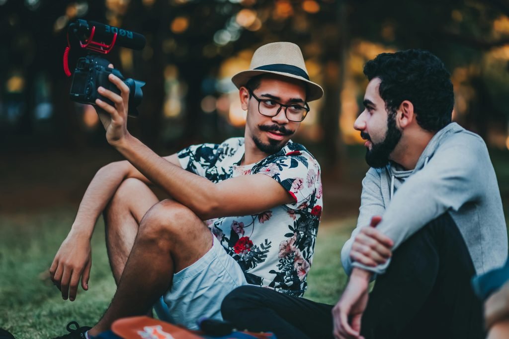 two photographers sitting in a garden